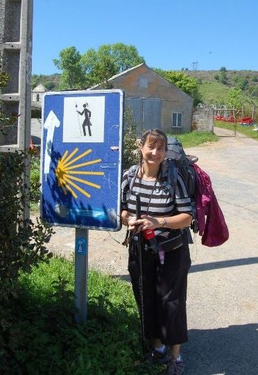 Peggy Patterson standing by  pilgrimage route sign